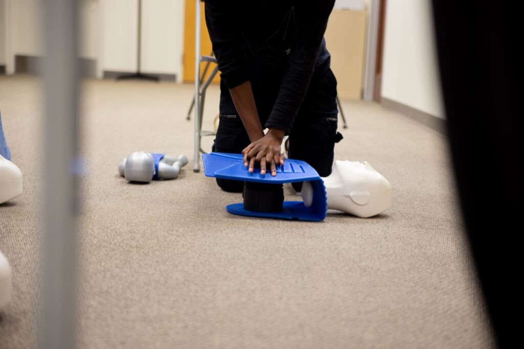 Trainee performing cpr in class